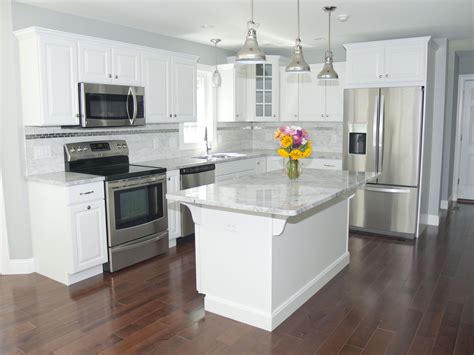 stainless steel appliances with light cabinets|modern kitchen with stainless steel countertops.